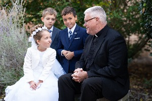 Fr_Don_with_1st_communion_students_2_1_ccexpress